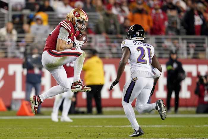 San Francisco 49ers tight end George Kittle catches a pass in front of Baltimore Ravens cornerback Brandon Stephens.